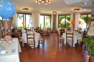 a banquet hall with tables and balloons on the walls at Hotel Danila in Portoferraio