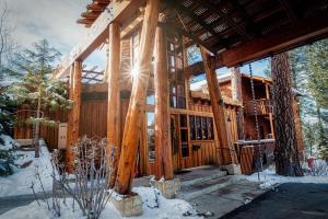 a log cabin in the woods in the snow at Gravity Haus Truckee-Tahoe in Truckee