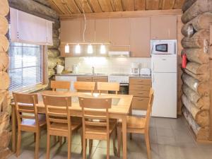 a kitchen with a table and chairs in a room at Holiday Home Mäentähti a by Interhome in Ruka
