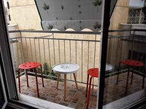 a small table and two stools on a balcony at ANNA in Athens