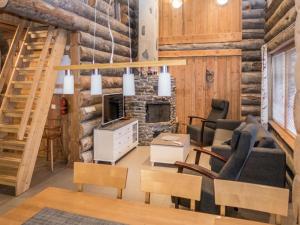 a living room filled with furniture and a fireplace at Holiday Home Mäentähti a by Interhome in Ruka