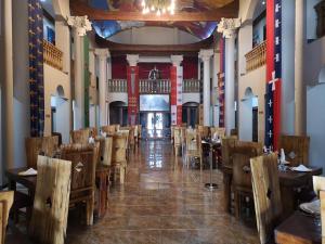 a dining hall with tables and chairs in a restaurant at Excalibur Boutique Hotel in Rustenburg