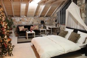 a bedroom with a christmas tree and a bed at Joanna in Stavroupoli