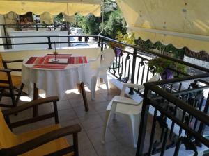 a table and chairs on the balcony of a restaurant at Litsa 1 in Metamorfosi