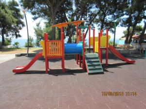a playground with a slide in a park at Litsa 1 in Metamorfosi