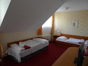 Llit o llits en una habitació de Hotel U Černého orla