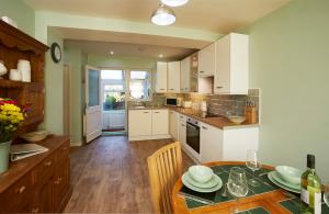 a kitchen with a table and a dining room at The Castle House in Whitby