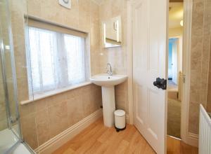a bathroom with a sink and a window and a shower at The Castle House in Whitby +20 photos