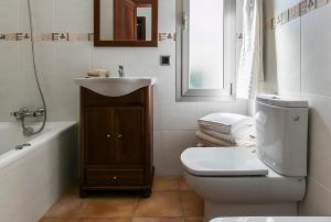 a bathroom with a sink and a toilet and a tub at Villa Baladres in Alcudia +29 photos