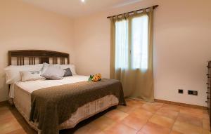 a bedroom with a bed and a large window at Villa Baladres in Alcudia