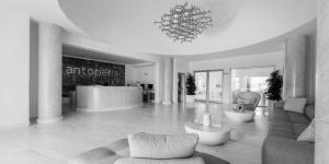 a lobby with a chandelier and a couch and chairs at Antoperla Luxury Hotel & Spa in Perissa
