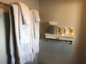 a bathroom with white towels hanging on a wall at Catalina Island Seacrest Inn in Avalon