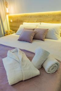 a bedroom with two beds with towels on them at Glossy Lodge in Thessaloniki