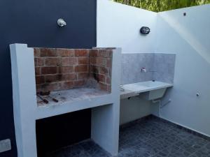 a bathroom with a sink and a brick wall at Santa Teresita Sobre El Monte in Santa Teresita +87 photos