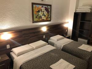 Postel nebo postele na pokoji v ubytování Hotel Masseilot
