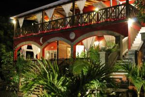 a house with a balcony with lights on it at Donkey on the Beach in Cobbs Cross