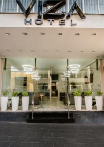 a store front with large white pots of plants at Hotel Viza in Arequipa