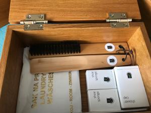 a wooden box filled with books and a wooden comb at Antik Hotel Sofia in Litomyšl
