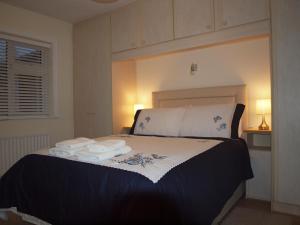 a bedroom with a bed with towels on it at Chez Sé in Drogheda