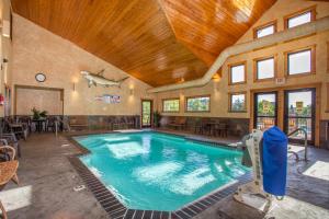 a swimming pool in a house with a wooden ceiling at The Village At Indian Point Resort in Branson
