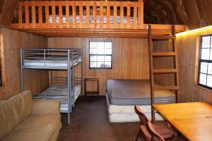 a room with two bunk beds and a couch at Abrams Creek Campground in Mount Storm