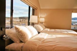 a hotel room with two beds and a large window at Iron Springs Luxury Lodge & Spa in Cedar City