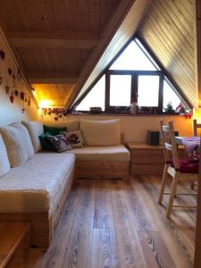 a living room with a couch and a window at Casa Margherita in Tarvisio