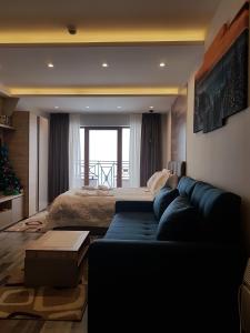 a living room with a couch and a bed at Ogi & Una Premijer 42 in Kopaonik +45 photos