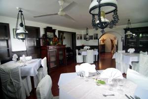 a dining room with white tables and a ceiling at Seaview Lodge and Restaurant in Nuku‘alofa