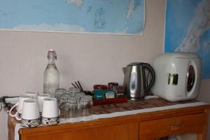 a counter with a coffee maker and a bottle of water at Jenny's Bed & Breakfast in New Plymouth