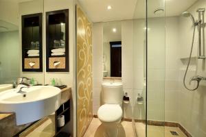 
a bathroom with a sink, toilet and shower at Prama Sanur Beach Bali in Sanur
