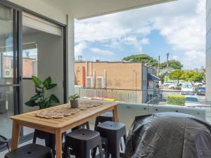 a room with a table and chairs and a large window at Rockpools 1 in Sawtell