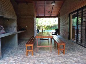 a dining room with a table and two benches at CASA FUNES in Funes