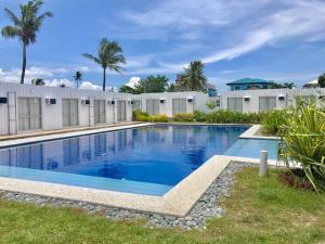 a large swimming pool with blue water in a yard at CUBE Baler in Baler