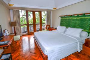En eller flere senge i et værelse på Prama Sanur Beach Bali