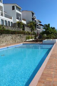 a swimming pool in front of some apartment buildings at Villa La Loma in Ixtapa