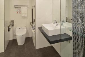 a white bathroom with a sink and a toilet at The Royal Park Hotel Tokyo Haneda in Tokyo