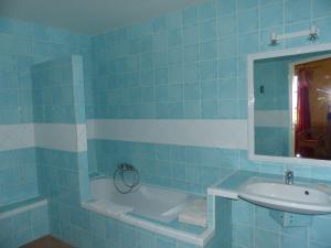 a blue tiled bathroom with a sink and a tub at La Ferme du petit Ségriès Bed and Breakfast in Moustiers-Sainte-Marie +114 photos