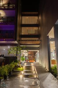 a hallway of a building with plants and lights at Mimpi Perhentian in Perhentian Island