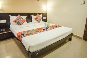 a bedroom with two beds in a room at Hotel Sunshine in Mysore