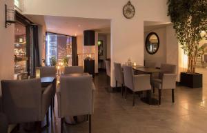 a dining room with a table and chairs and a clock at Best Western Hotel City Gavle in Gävle