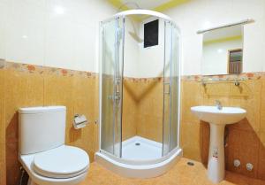 a bathroom with a shower and a toilet and a sink at Hotel UI Inn in Hulhumale