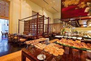 a restaurant with a bunch of food on display at Indochine Palace in Hue +55 photos