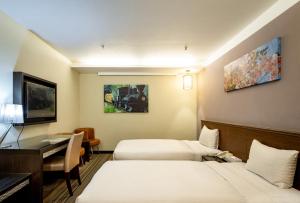 Postel nebo postele na pokoji v ubytování Yoyo Hotel