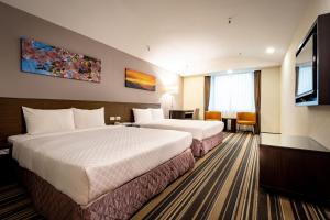 Postel nebo postele na pokoji v ubytování Yoyo Hotel