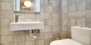 a bathroom with a sink and a toilet at Ekatis Houses in Sani in Sani Beach +31 photos