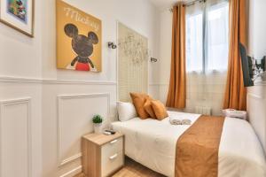 a small bedroom with a bed and a window at 72 - Mermoz Mickey Mouse in Paris