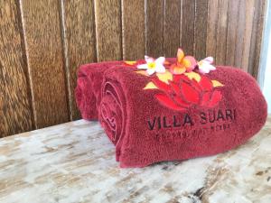 a red towel with a villa sun sign on it at Villa Suari I in Padangbai +30 photos