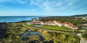 an aerial view of a resort near the ocean at Haevichi Hotel & Resort Jeju in Seogwipo