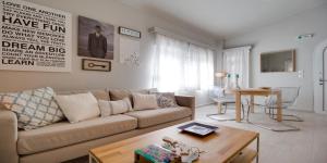 a living room with a couch and a table at Ekatis Houses in Sani in Sani Beach